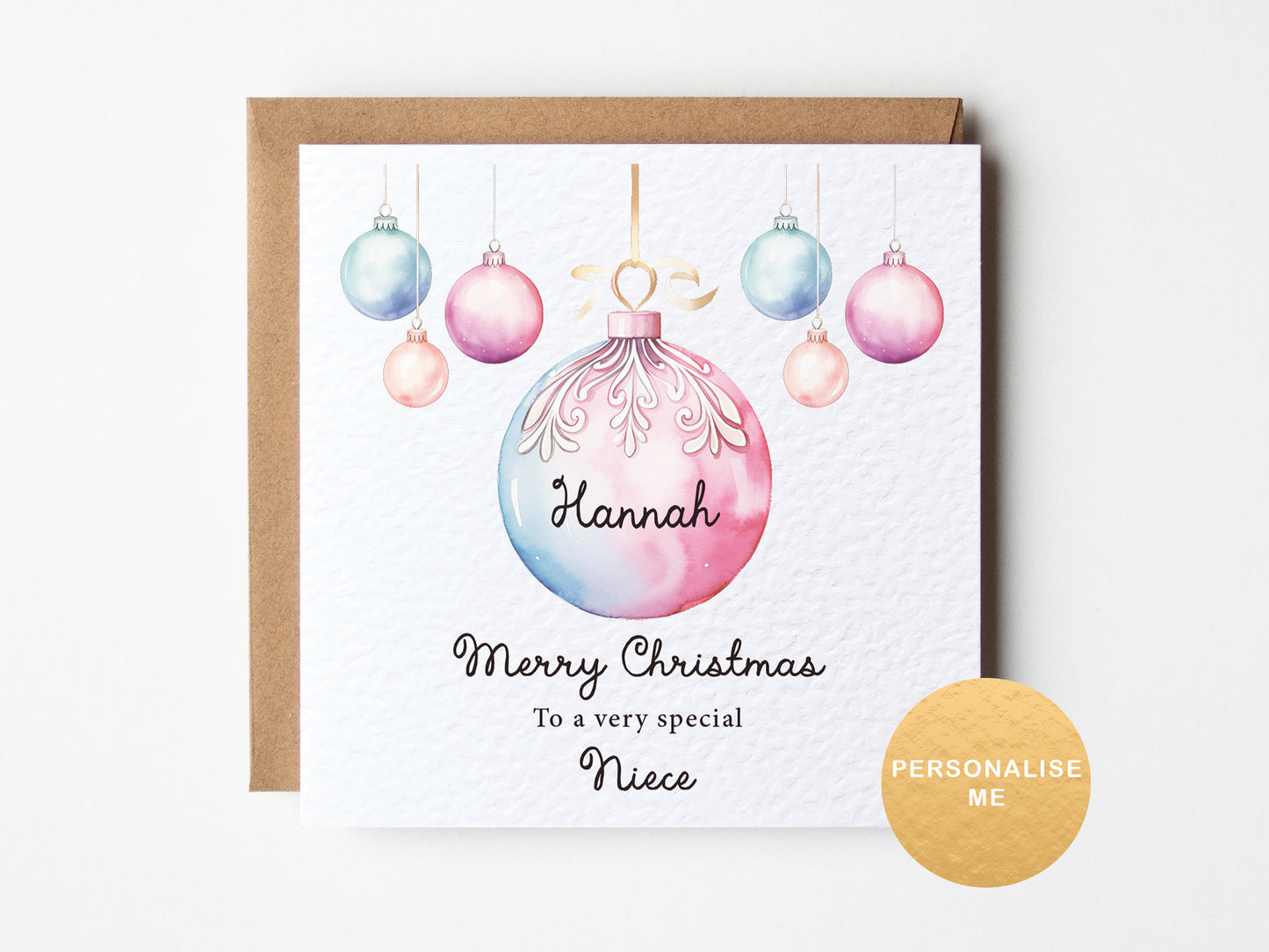 Personalized Christmas card with colorful ornaments and a gold envelope on a white background